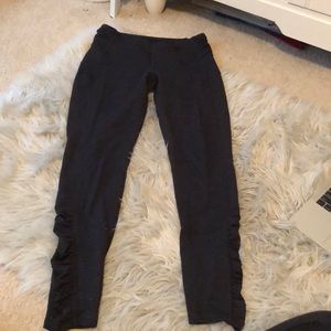 Black full-length leggings with ruffles down sides